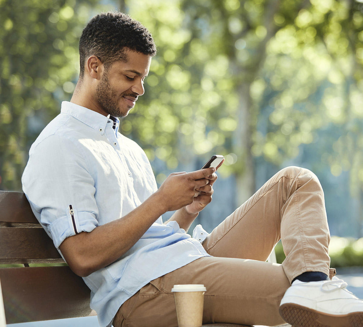Black Male looking at a phone